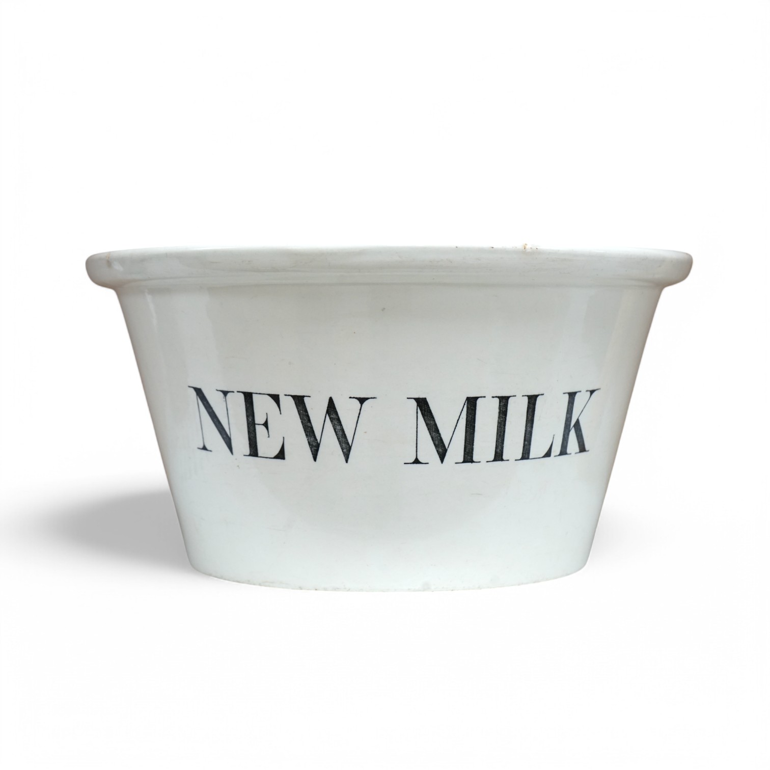 A Dairy Supply Co. Ltd 'New Milk' cream glazed dairy bowl, 34cm diameter. Condition - some marks to top edge of bowl.